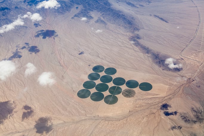 aerial green pivot fields in dry landscape