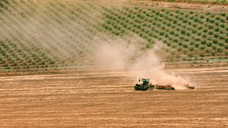 plough dust california orchard in background