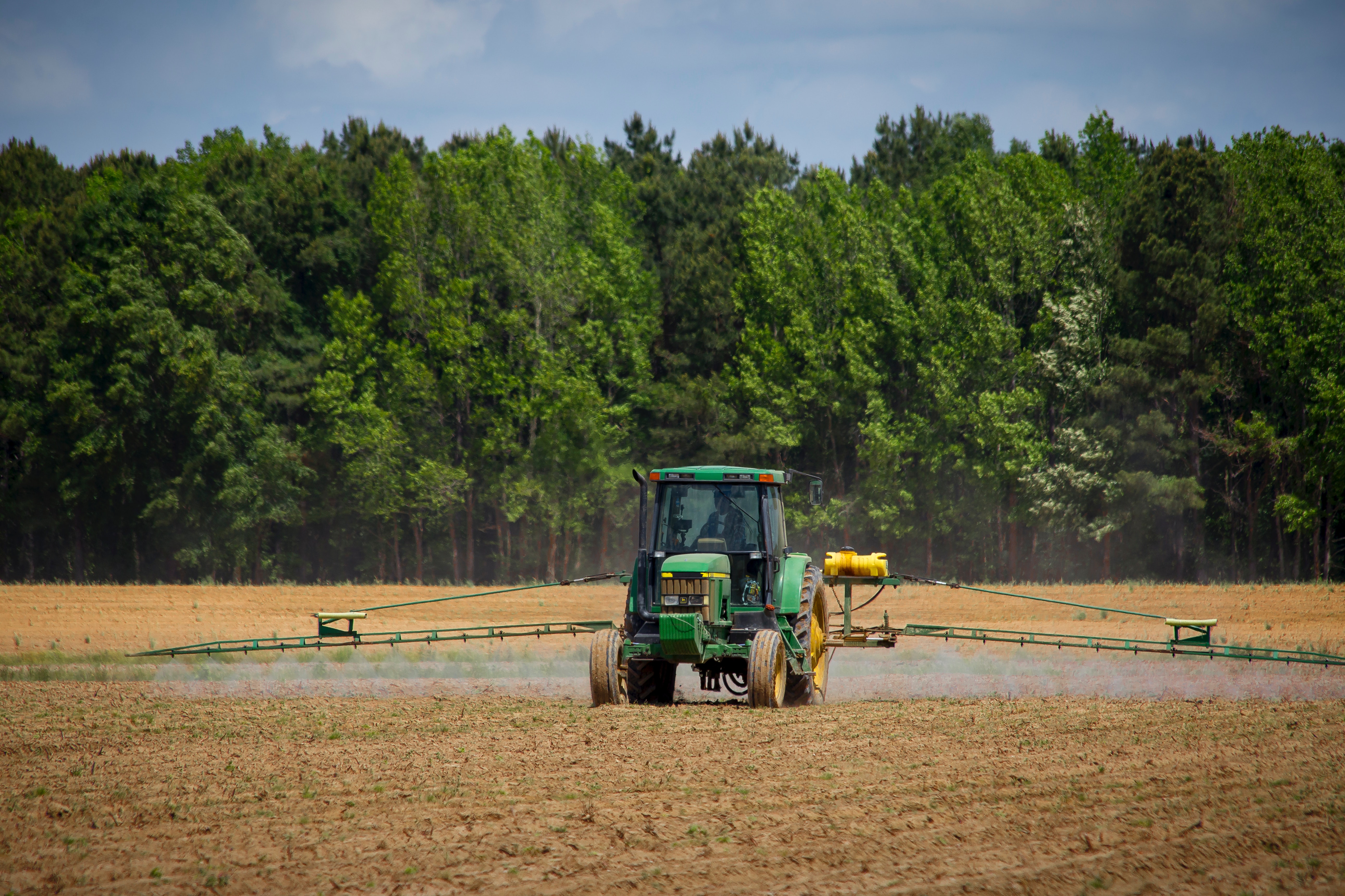 Tractor spraying a field